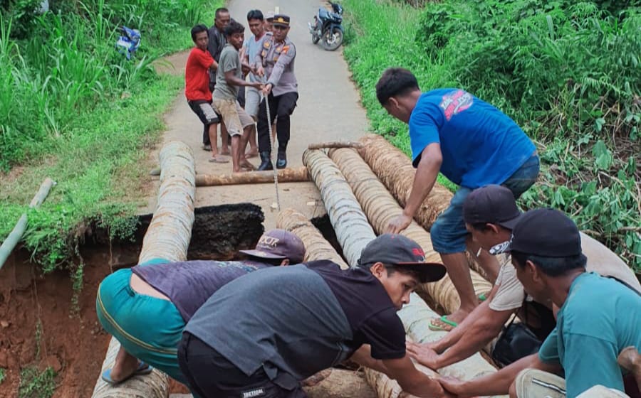 Gotong Royong, Warga dibantu TNI - Polri Membuat Jembatan Darurat di Jalan Putus